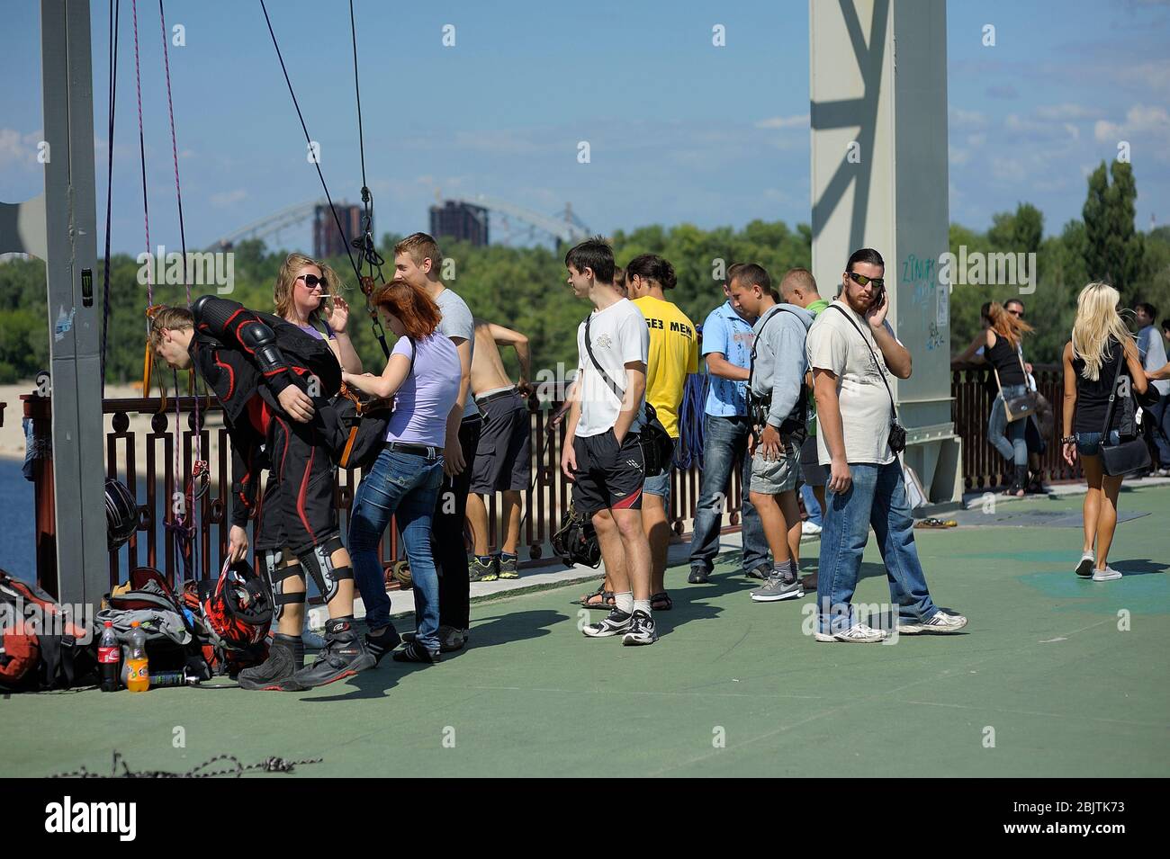 Rope jumping. Worker attaching rigging to the young boy before jumping
