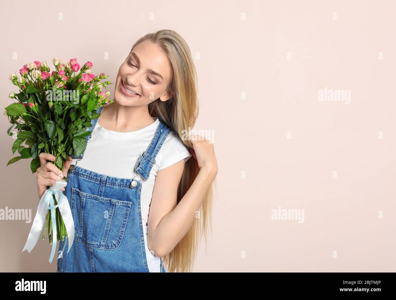 Beautiful young woman with bouquet of roses on color background Stock ...