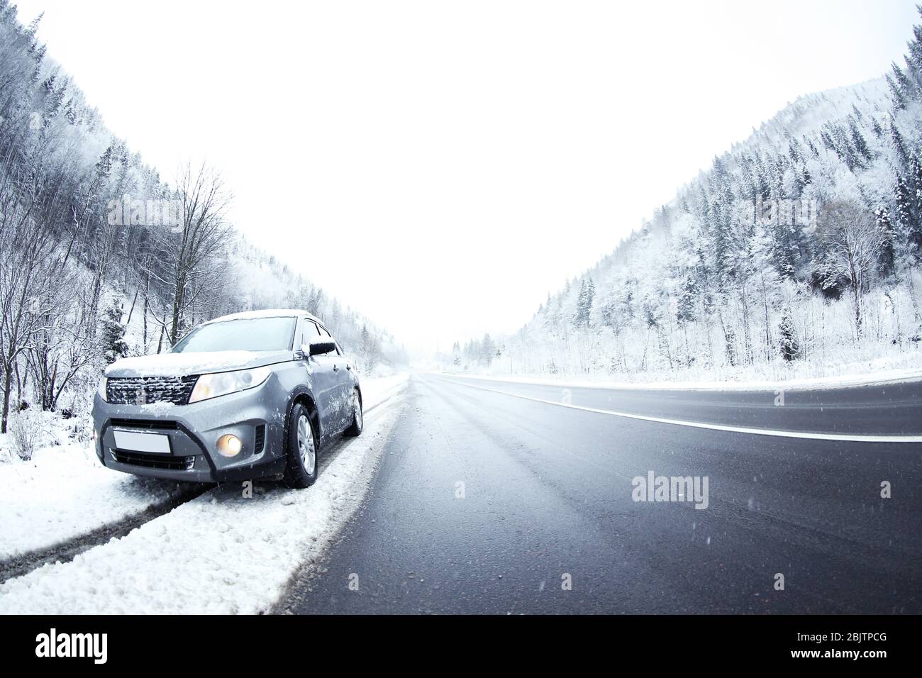 Car on country road in snowy weather Stock Photo - Alamy