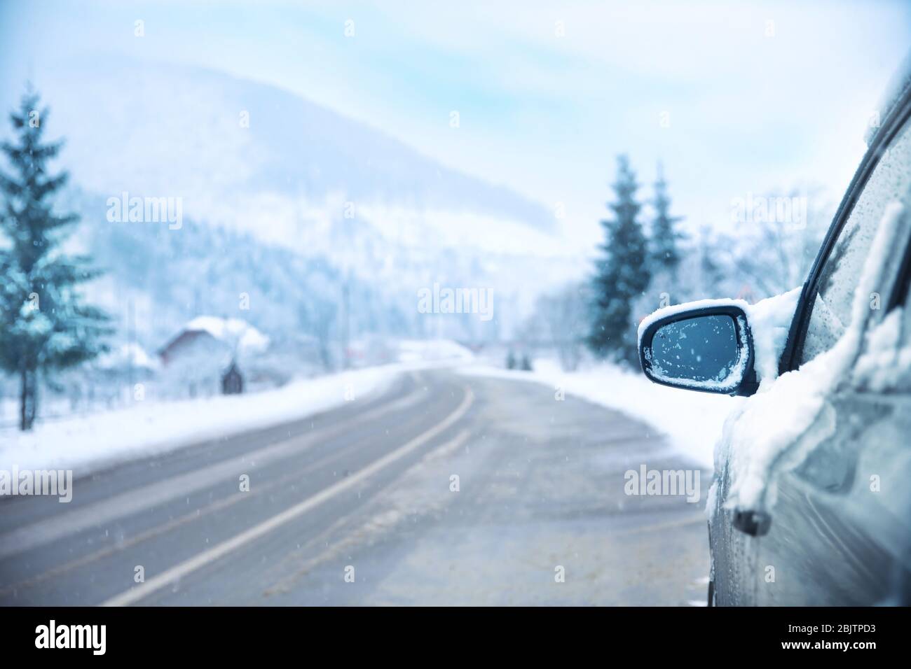 Car on country road in snowy winter day Stock Photo - Alamy