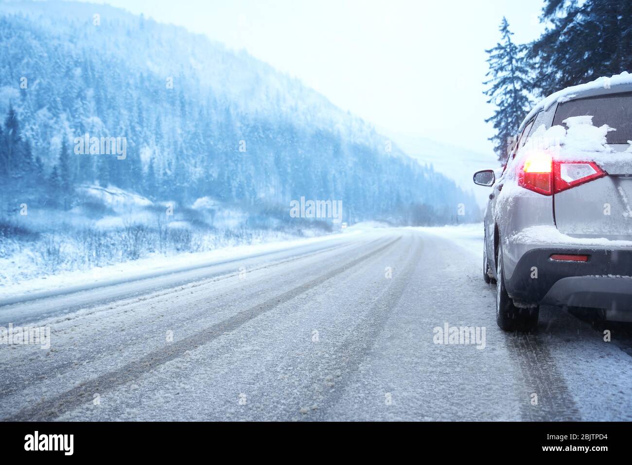 Car on country road in snowy winter day Stock Photo - Alamy