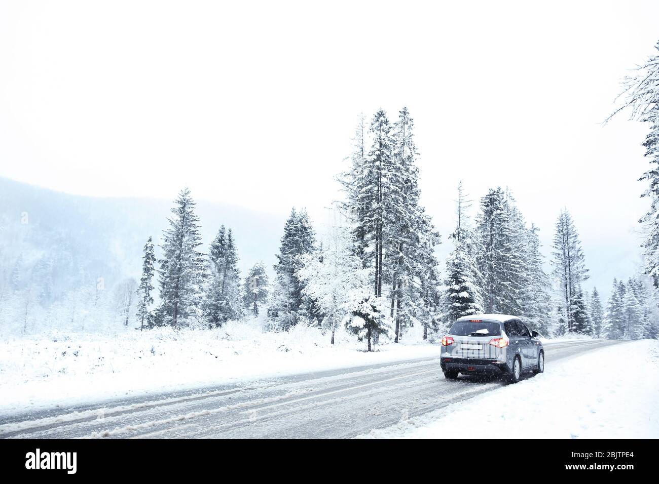 Car on country road in snowy weather Stock Photo - Alamy