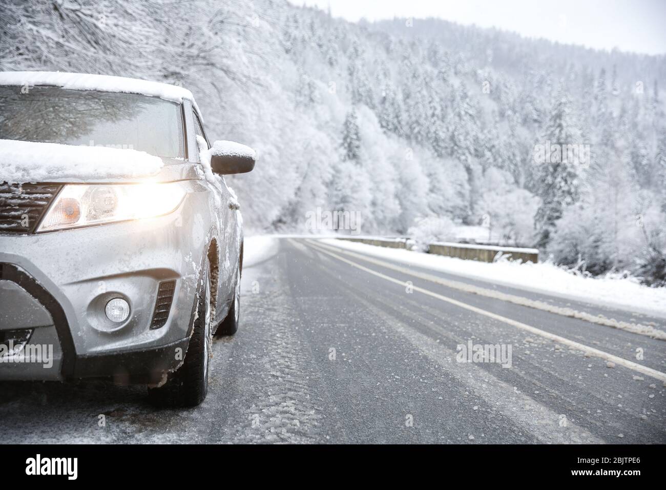 Car on country road in snowy weather Stock Photo - Alamy