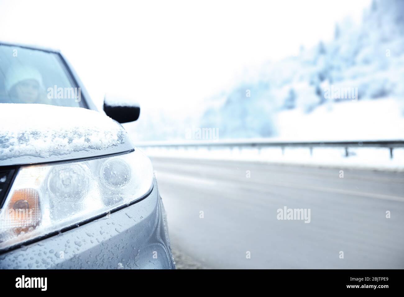 Front view of car on country road in snowy weather Stock Photo - Alamy