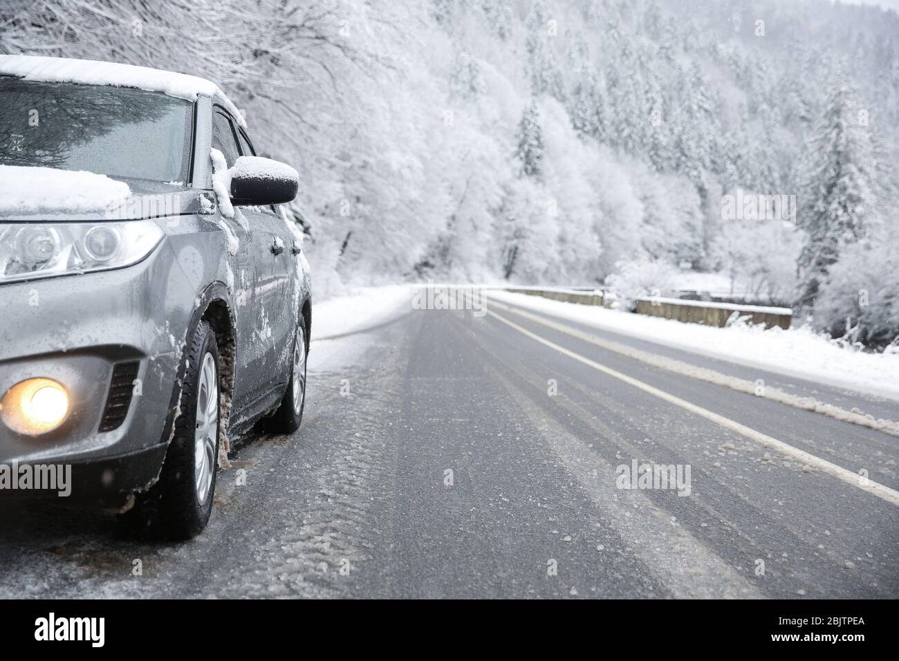 Car on country road in snowy weather Stock Photo - Alamy