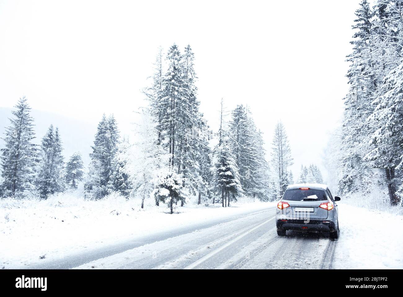 Car on country road in snowy weather Stock Photo - Alamy