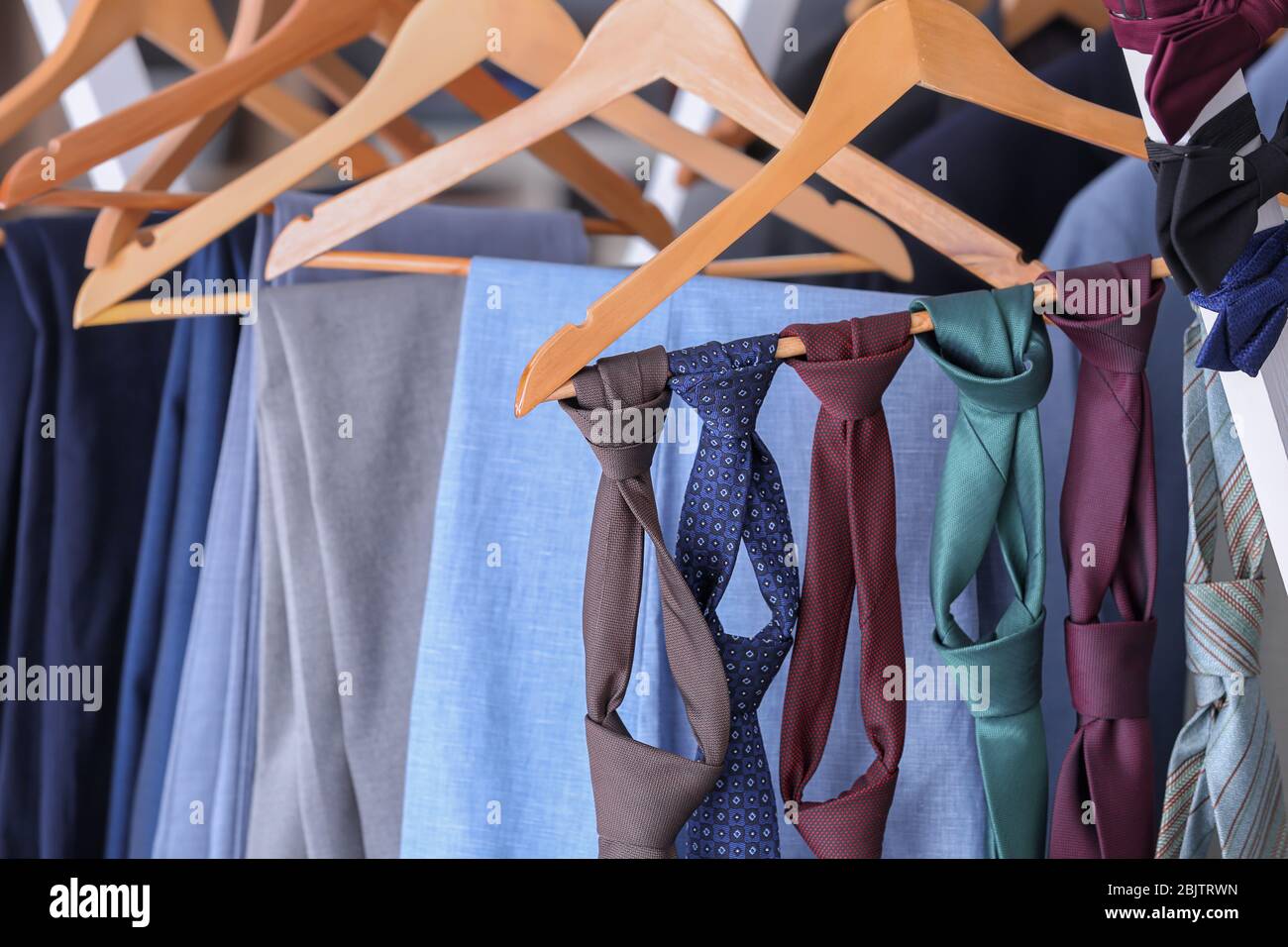 Hangers with suits and ties in tailor's Stock Photo Alamy