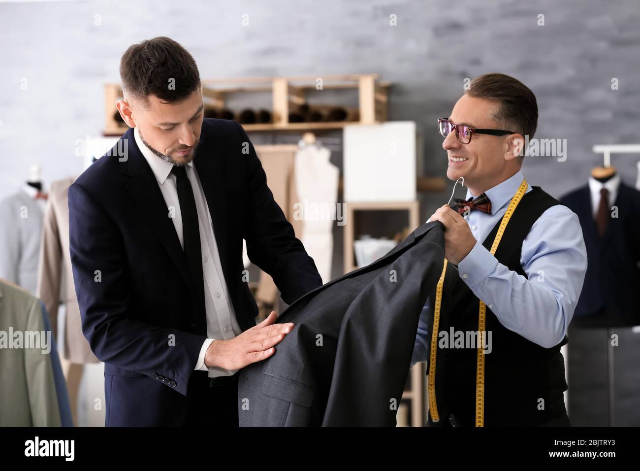 Mature tailor measuring client hi-res stock photography and images - Alamy