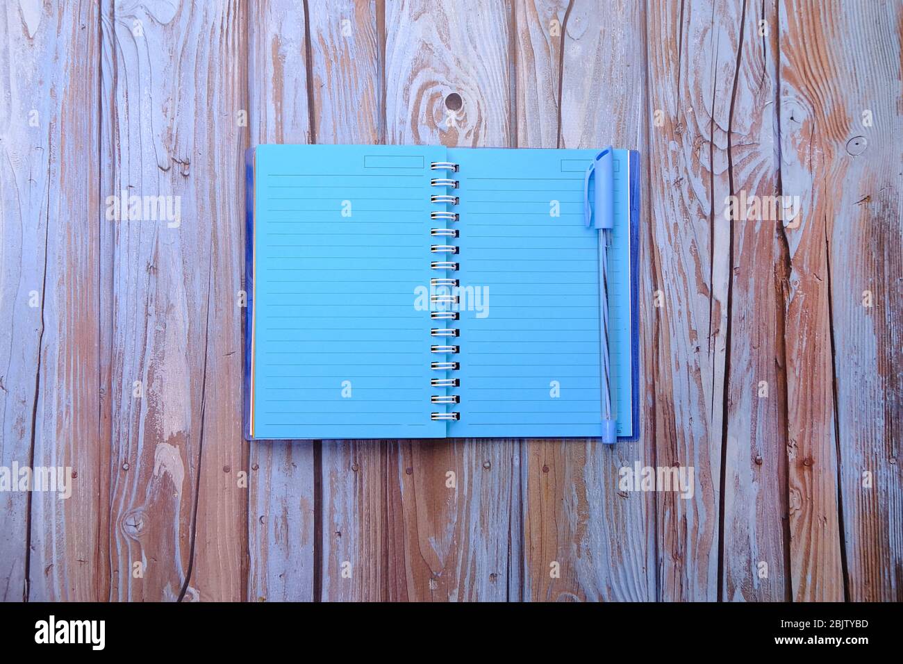 empty notepad with pencil on wooden background Stock Photo