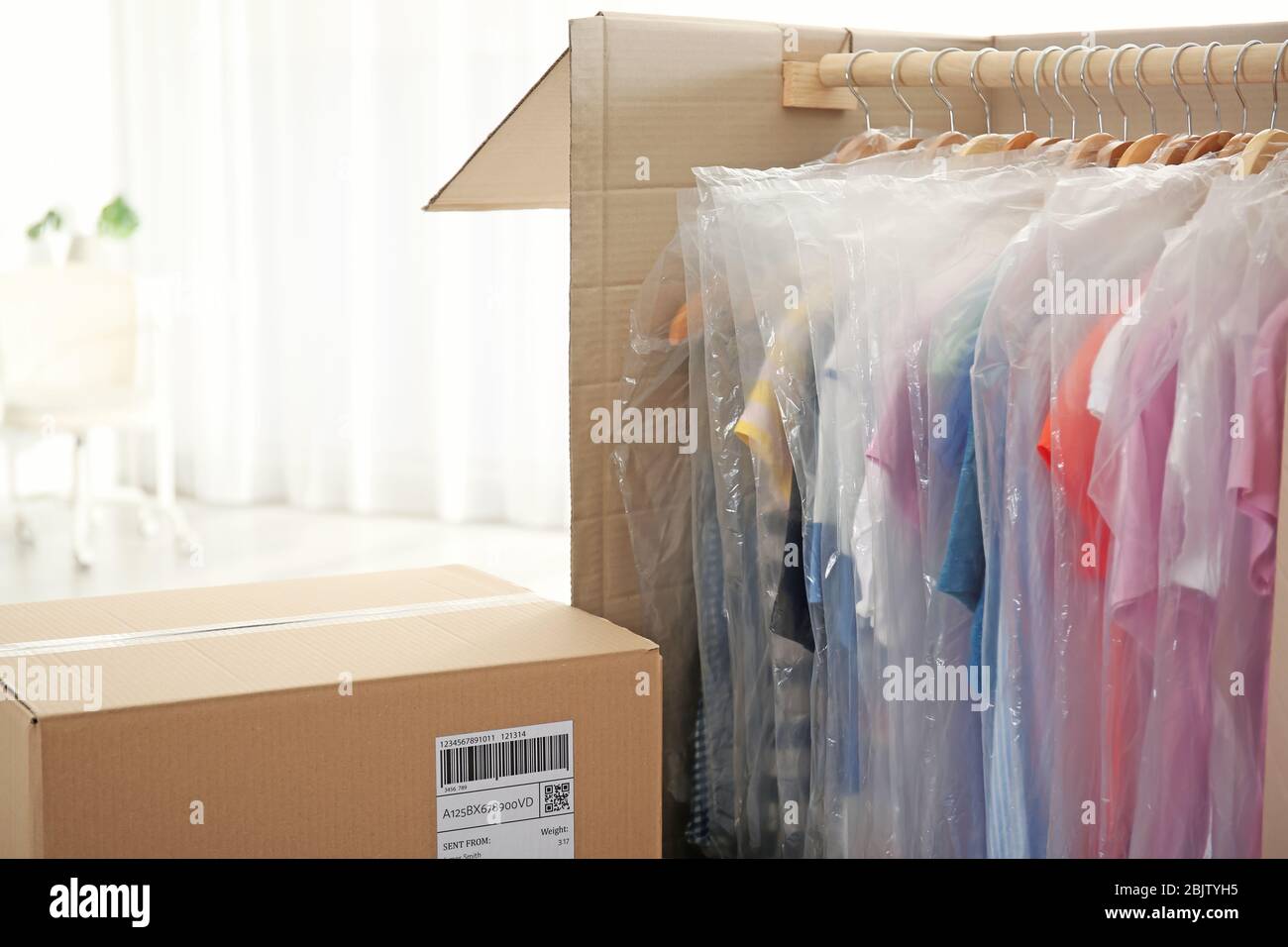 Wardrobe boxes with clothes indoors Stock Photo Alamy
