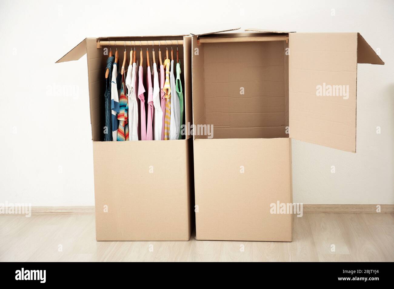 Wardrobe boxes with clothes indoors Stock Photo Alamy