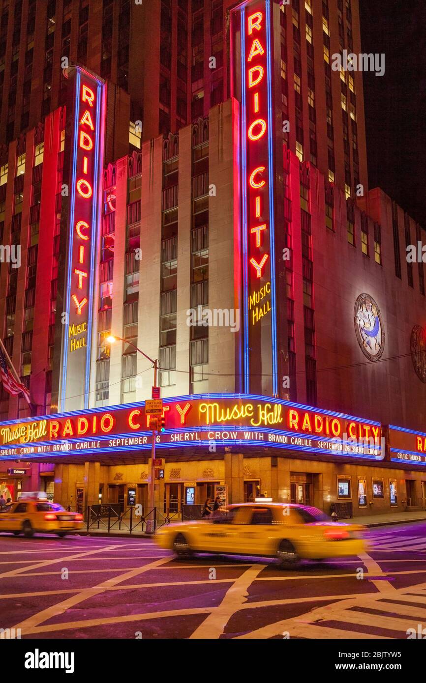 Taxis drive by Radio City Music Hall in Manhattan, New York City, USA Stock Photo