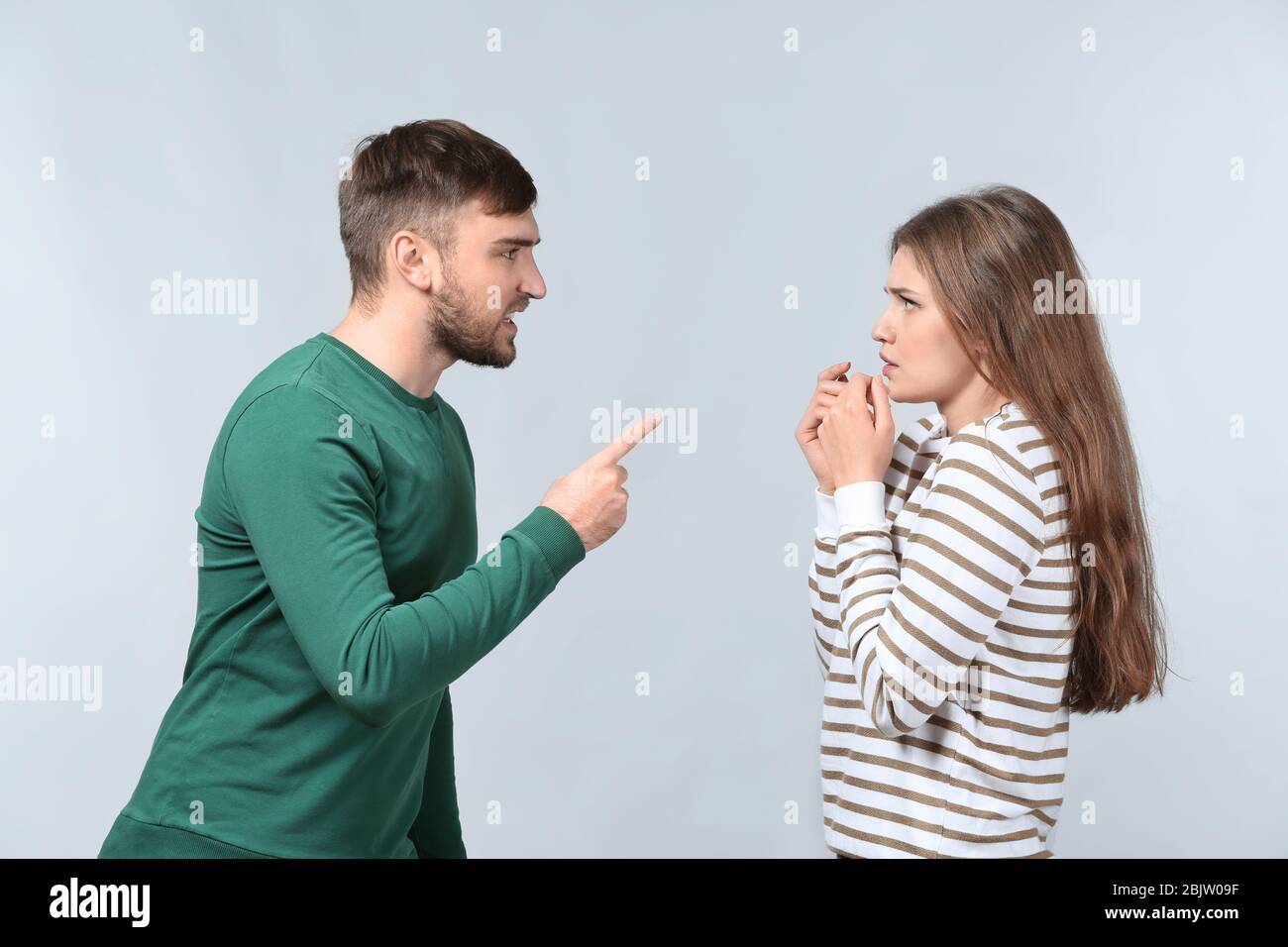 Couple arguing on light background. Problems in relationship Stock ...