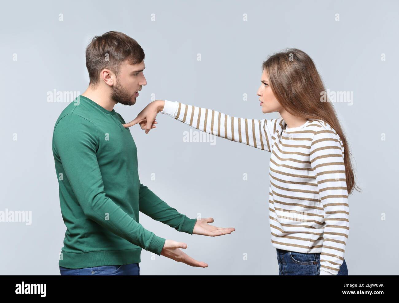 Couple arguing on light background. Problems in relationship Stock ...