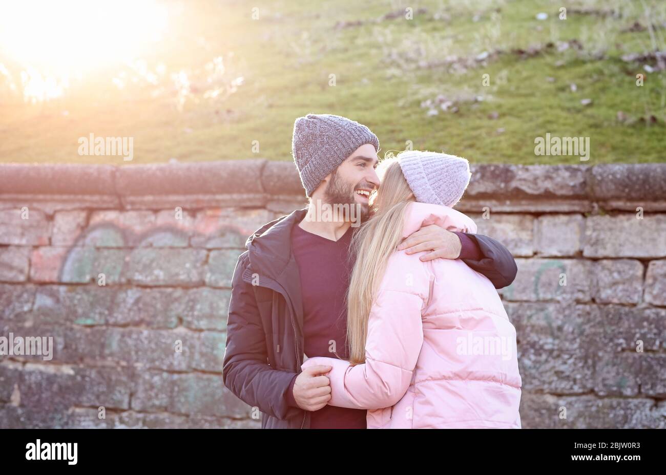 Young romantic couple hugging outdoors Stock Photo - Alamy