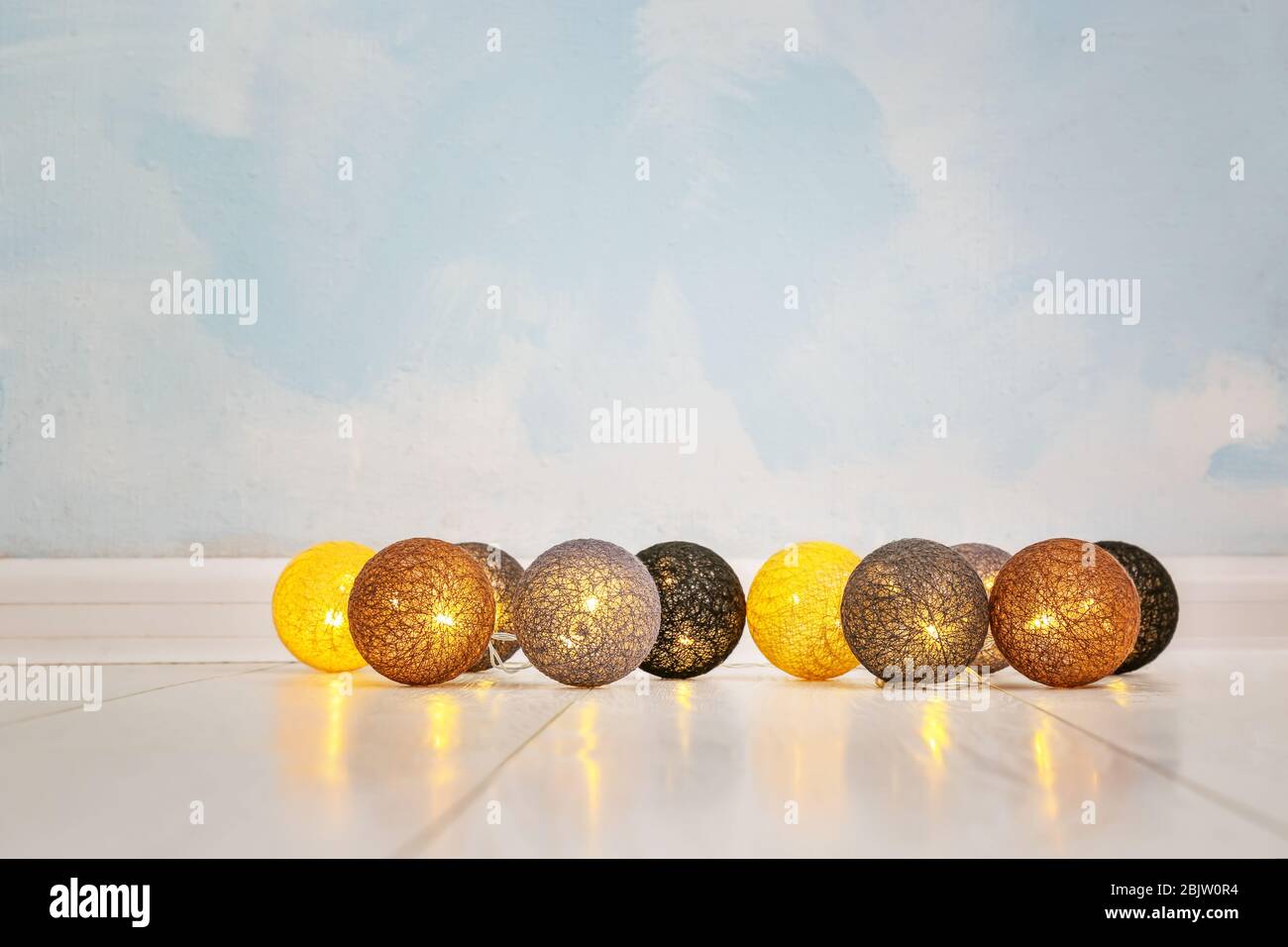 Glowing Christmas lights on floor Stock Photo Alamy