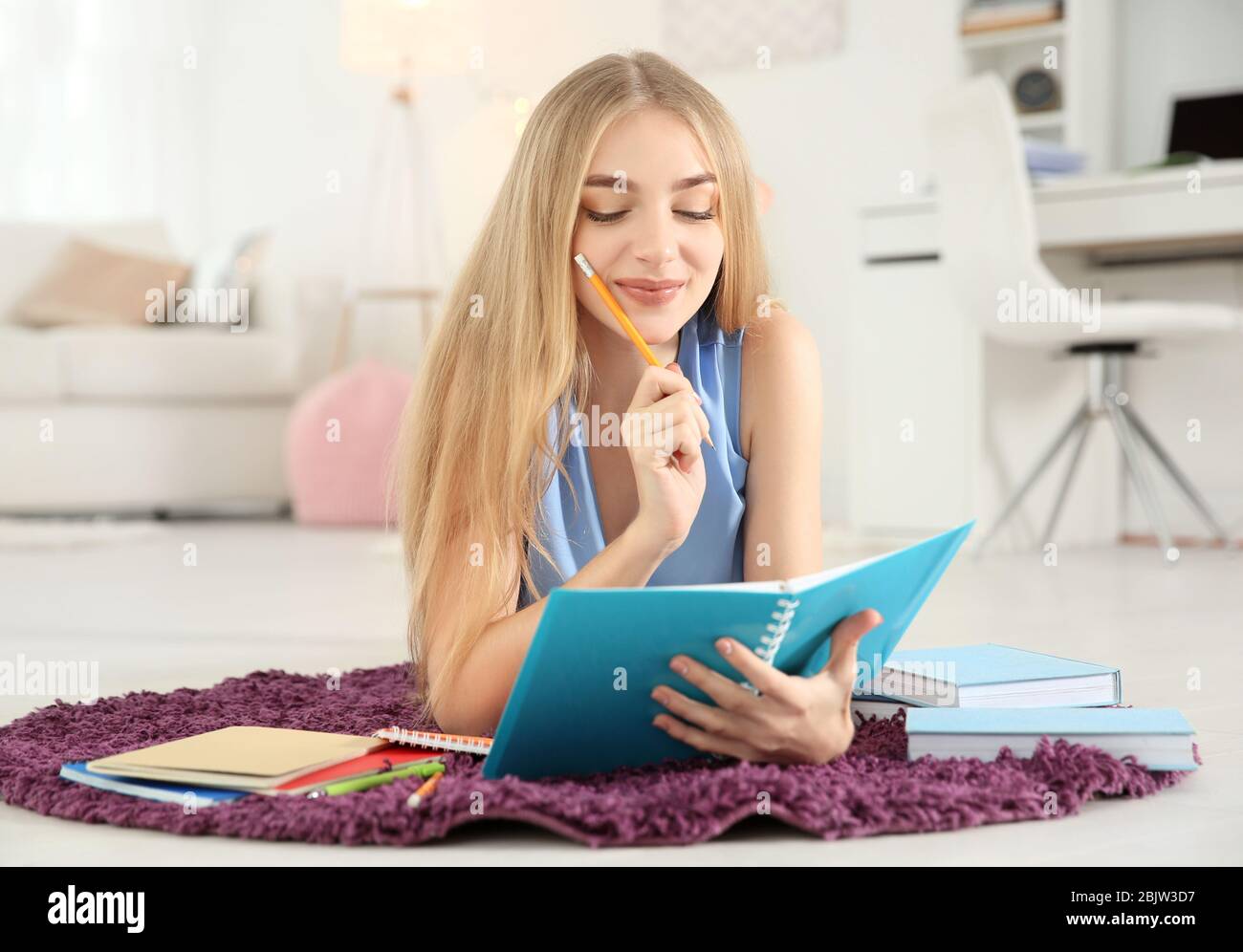 Female student preparing for exam indoors Stock Photo