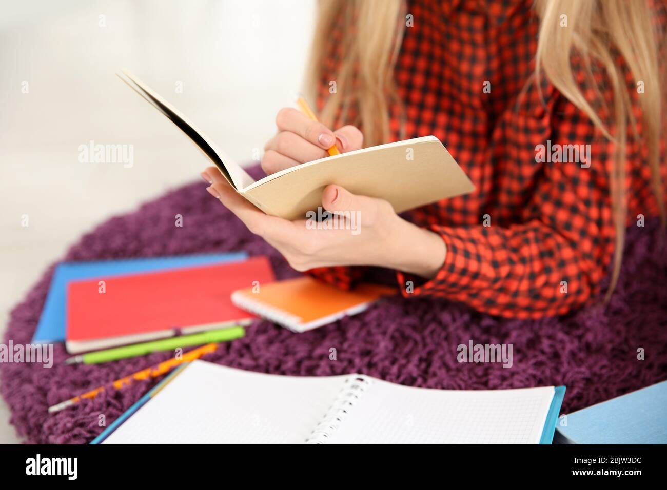 Female student preparing for exam indoors Stock Photo