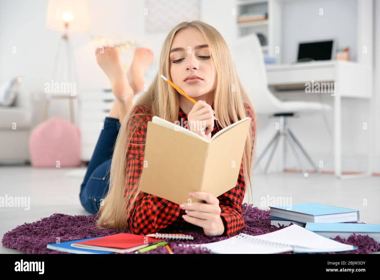 Female student preparing for exam indoors Stock Photo