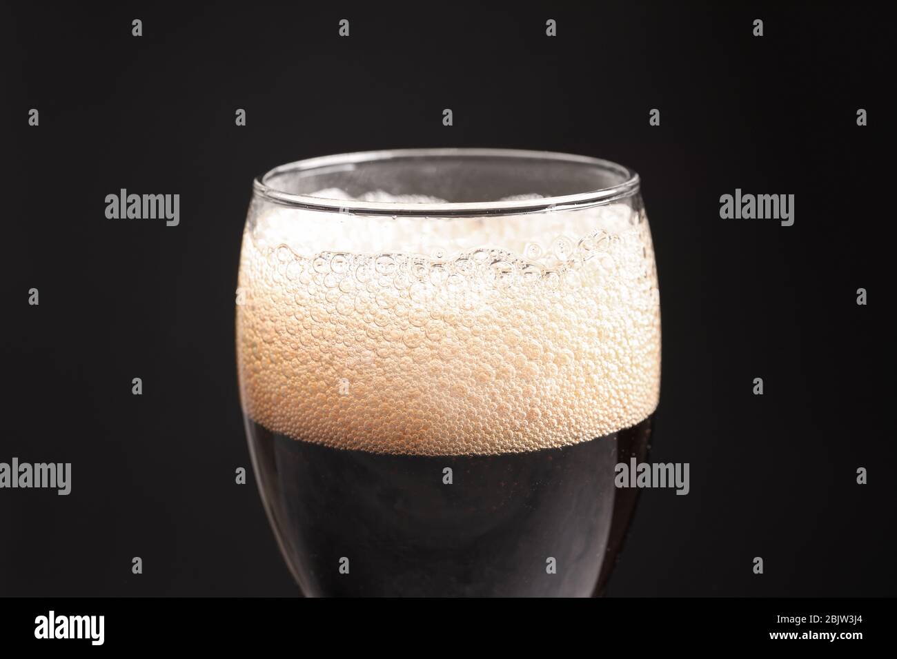 Glass of refreshing cola on black background, closeup Stock Photo - Alamy