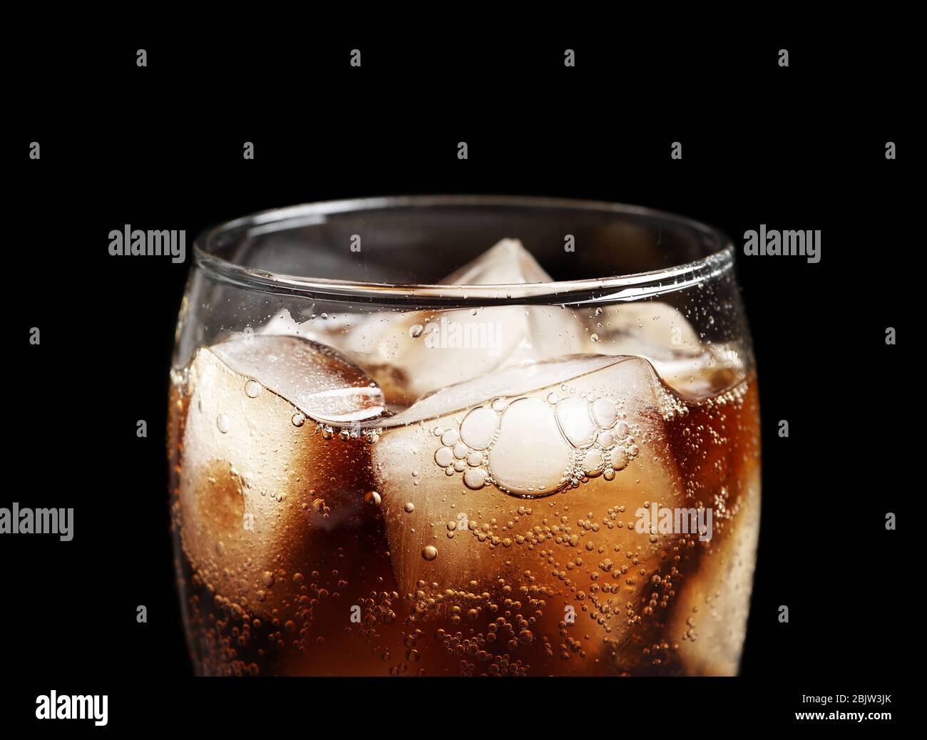 Glass of refreshing cola with ice on black background, closeup Stock ...