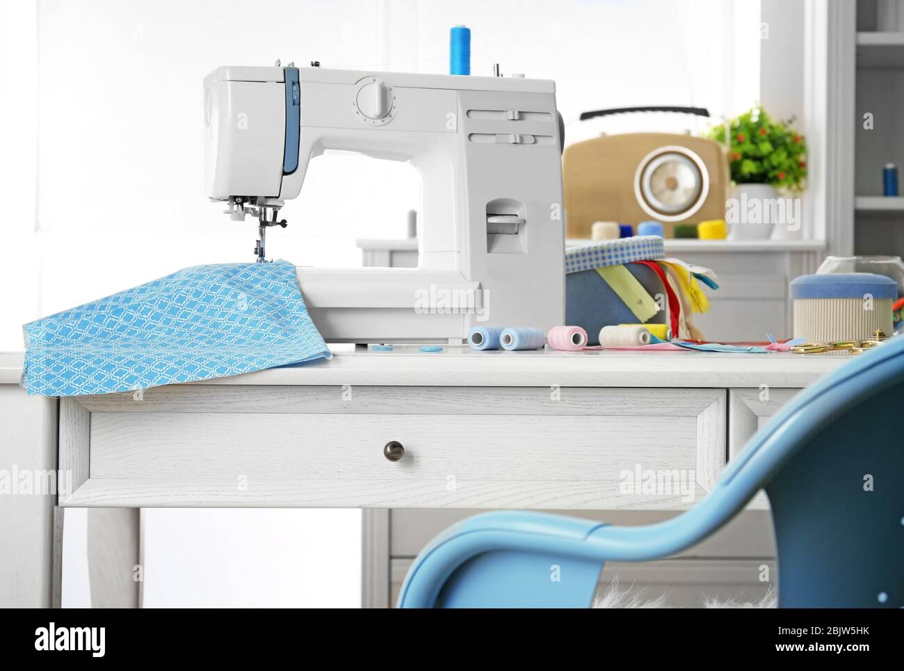 Sewing machine with fabric on table in tailor Stock Photo Alamy