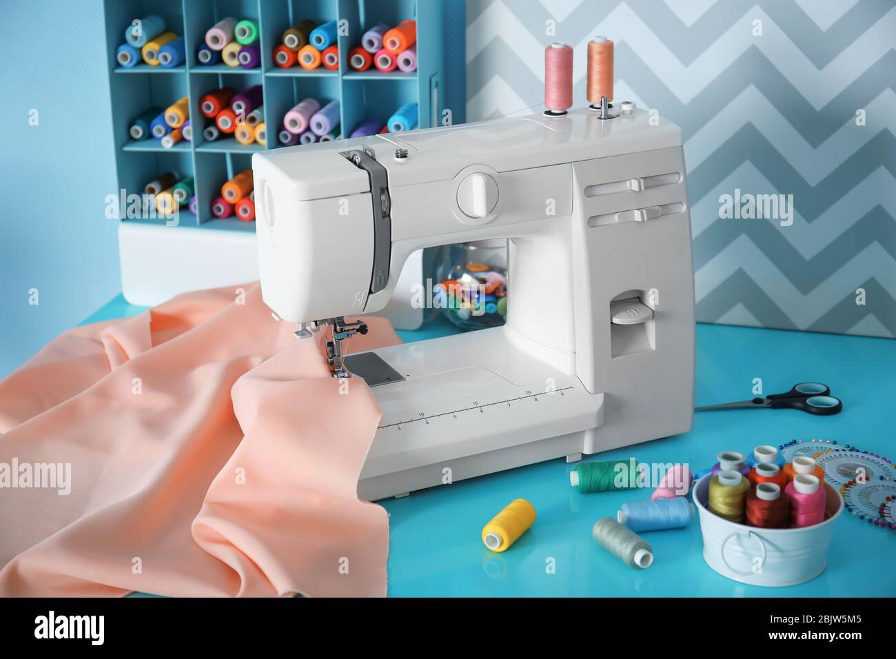 Sewing machine with fabric on table in tailor Stock Photo Alamy