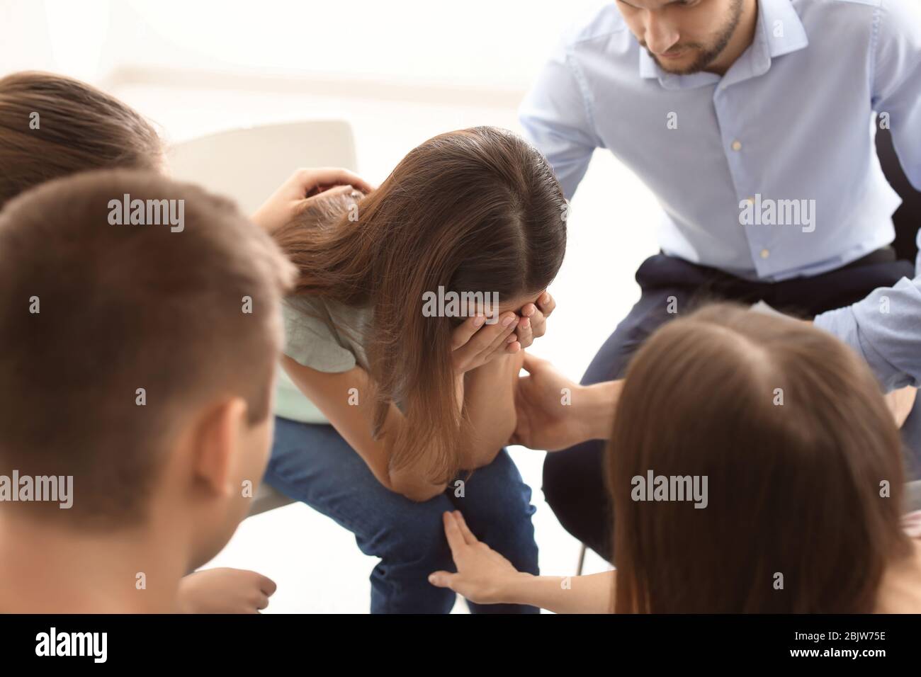 People consoling sad woman at group therapy session Stock Photo - Alamy