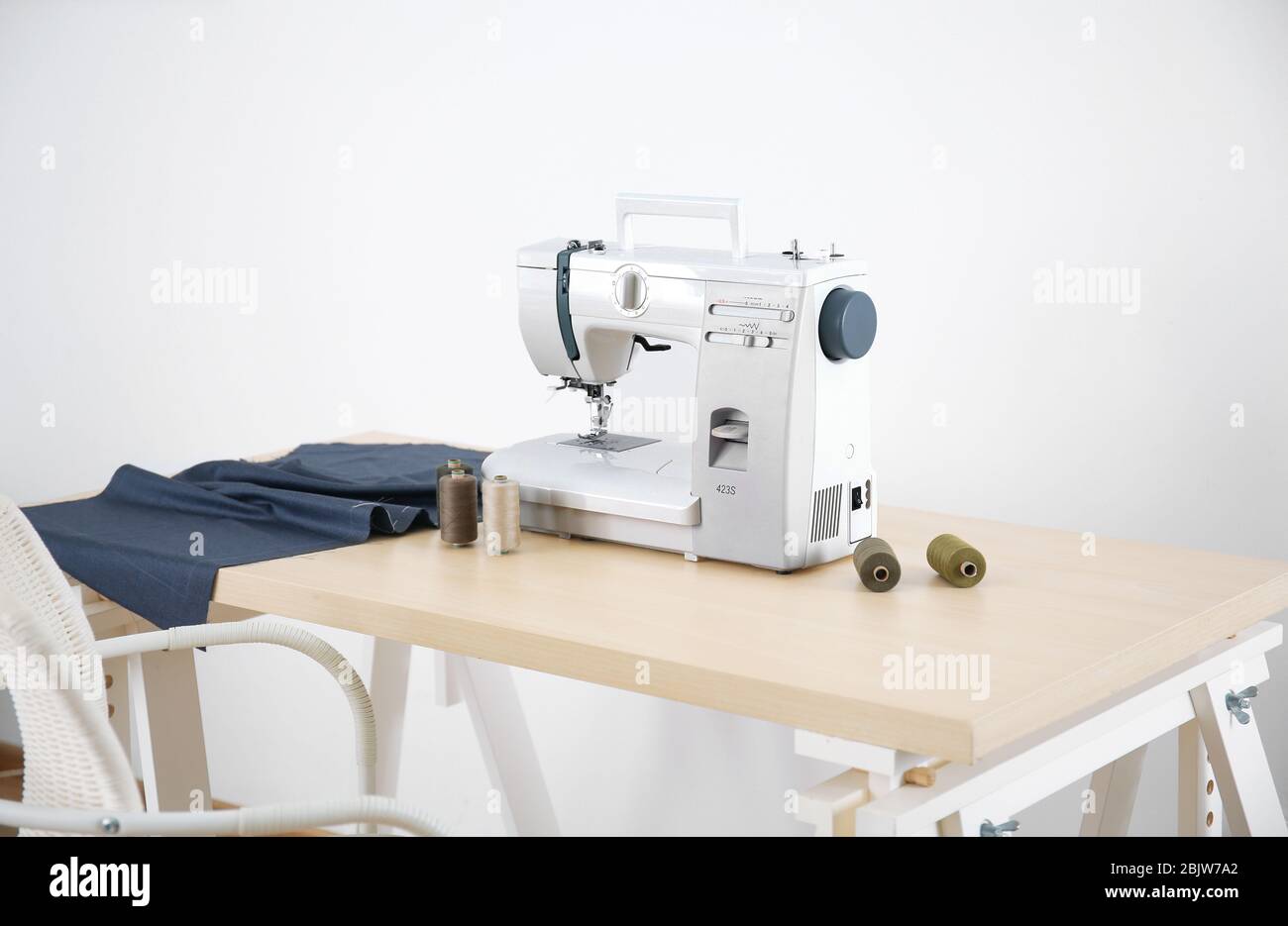Sewing machine on table in tailor's Stock Photo Alamy