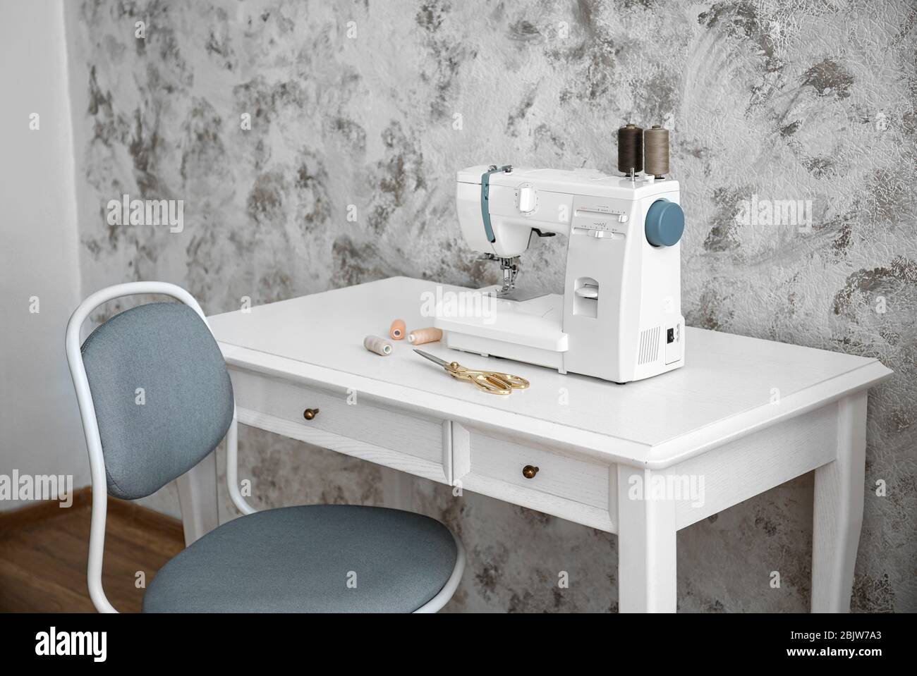 Sewing machine on table in tailor's Stock Photo Alamy