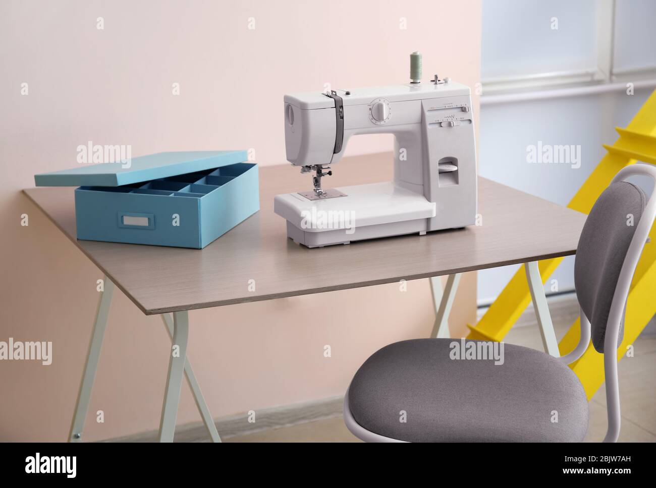 Sewing machine on table in tailor's Stock Photo Alamy