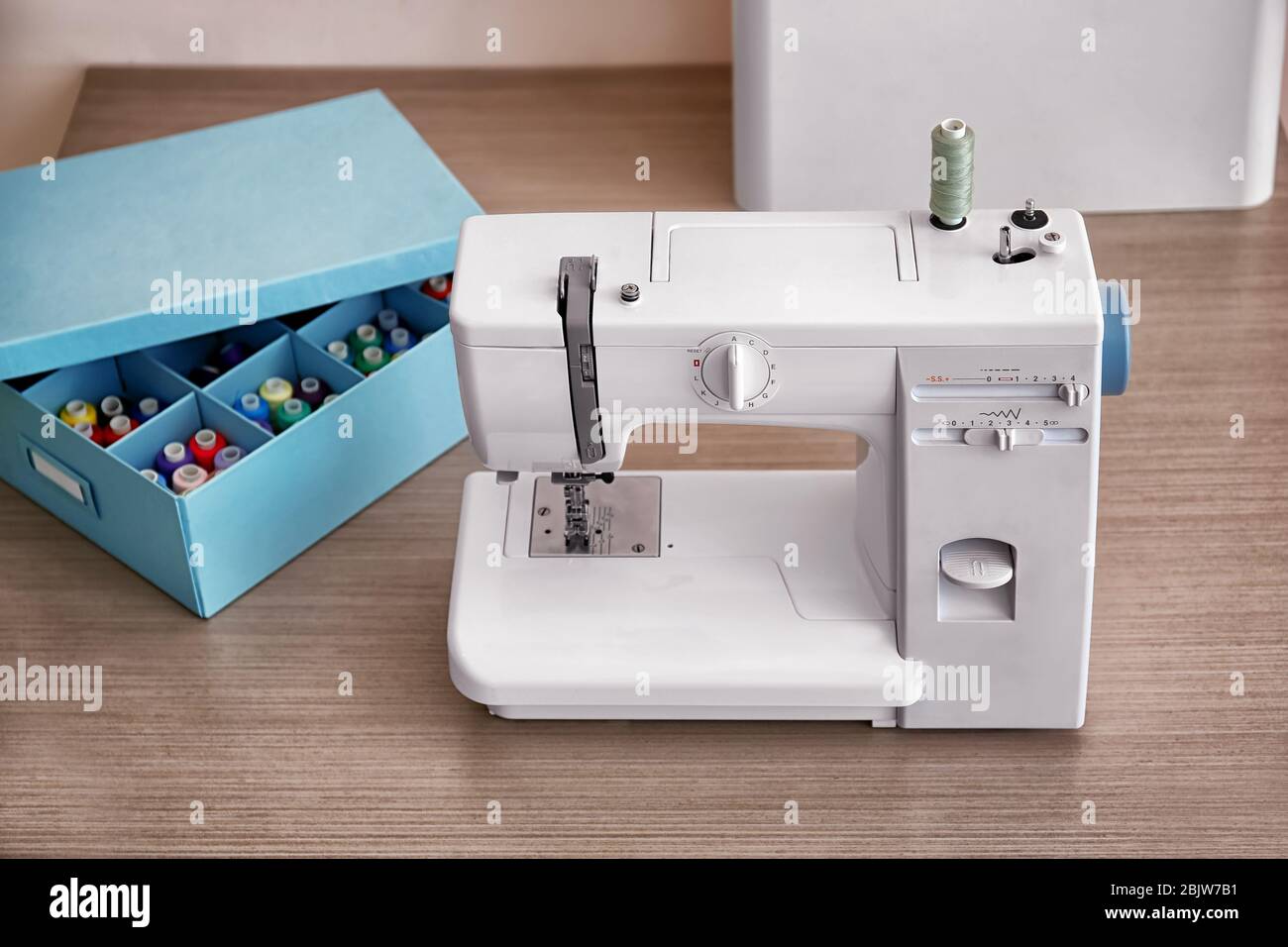 Sewing machine on table in tailor's Stock Photo Alamy