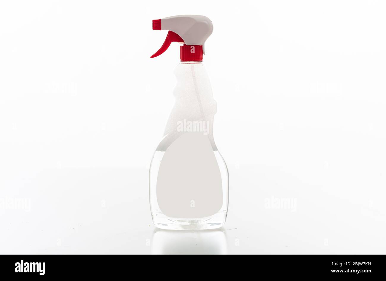 Cleaning spray bottle clear with red trigger isolated against white background. Chemical detergent product no name template, blank empty label, copy s Stock Photo