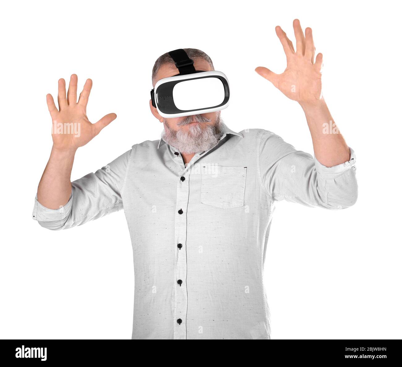 Senior man with virtual reality headset on white background Stock Photo ...