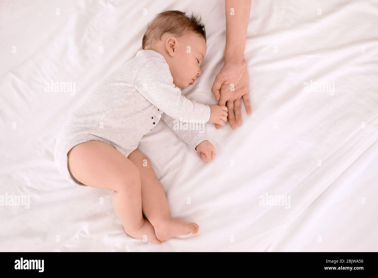 baby holding bed