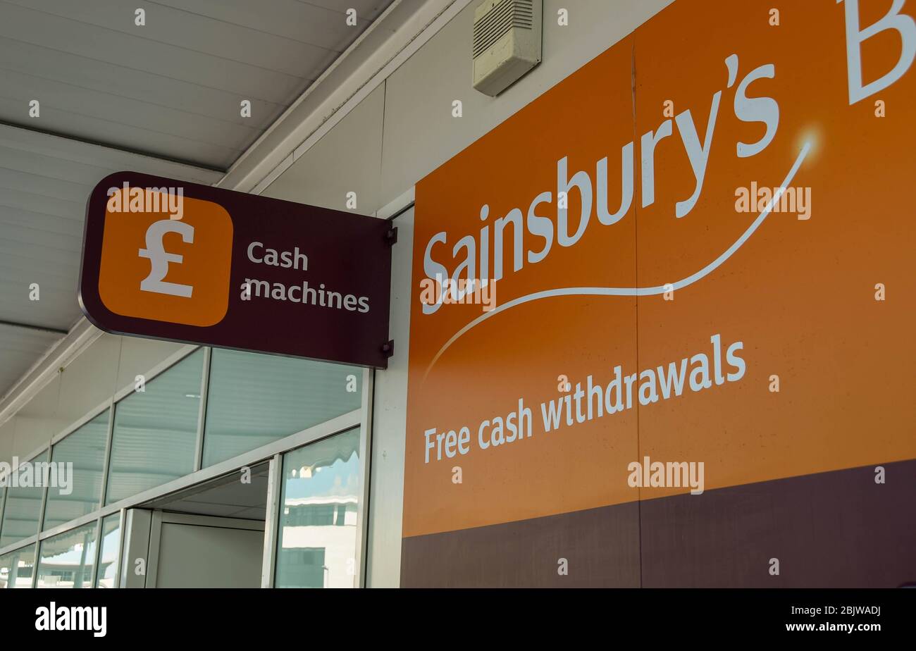 SWANSEA, WALES - JULY 2018: Exterior of a Sainsbury's supermarket in Swansea with a sign for a cash point machine Stock Photo