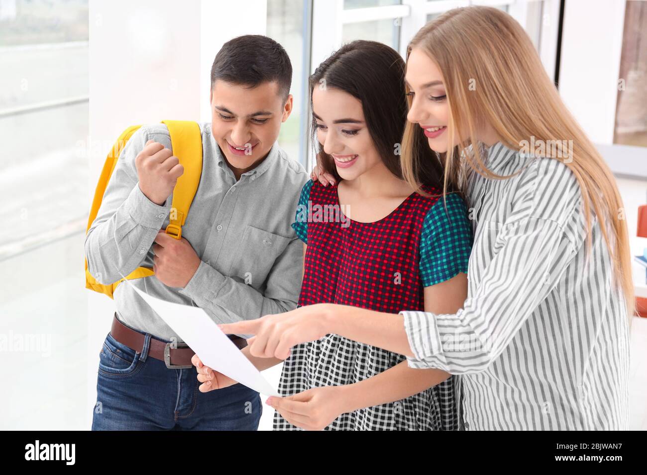 Excited students finding out their excellent grades for exam indoors ...