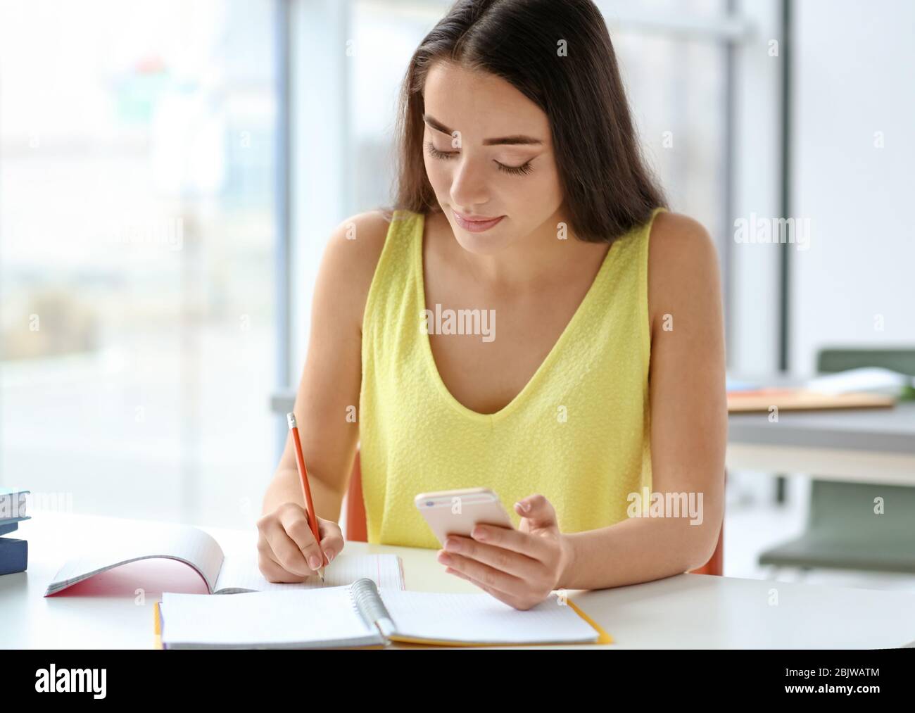 Student preparing for exam in classroom Stock Photo