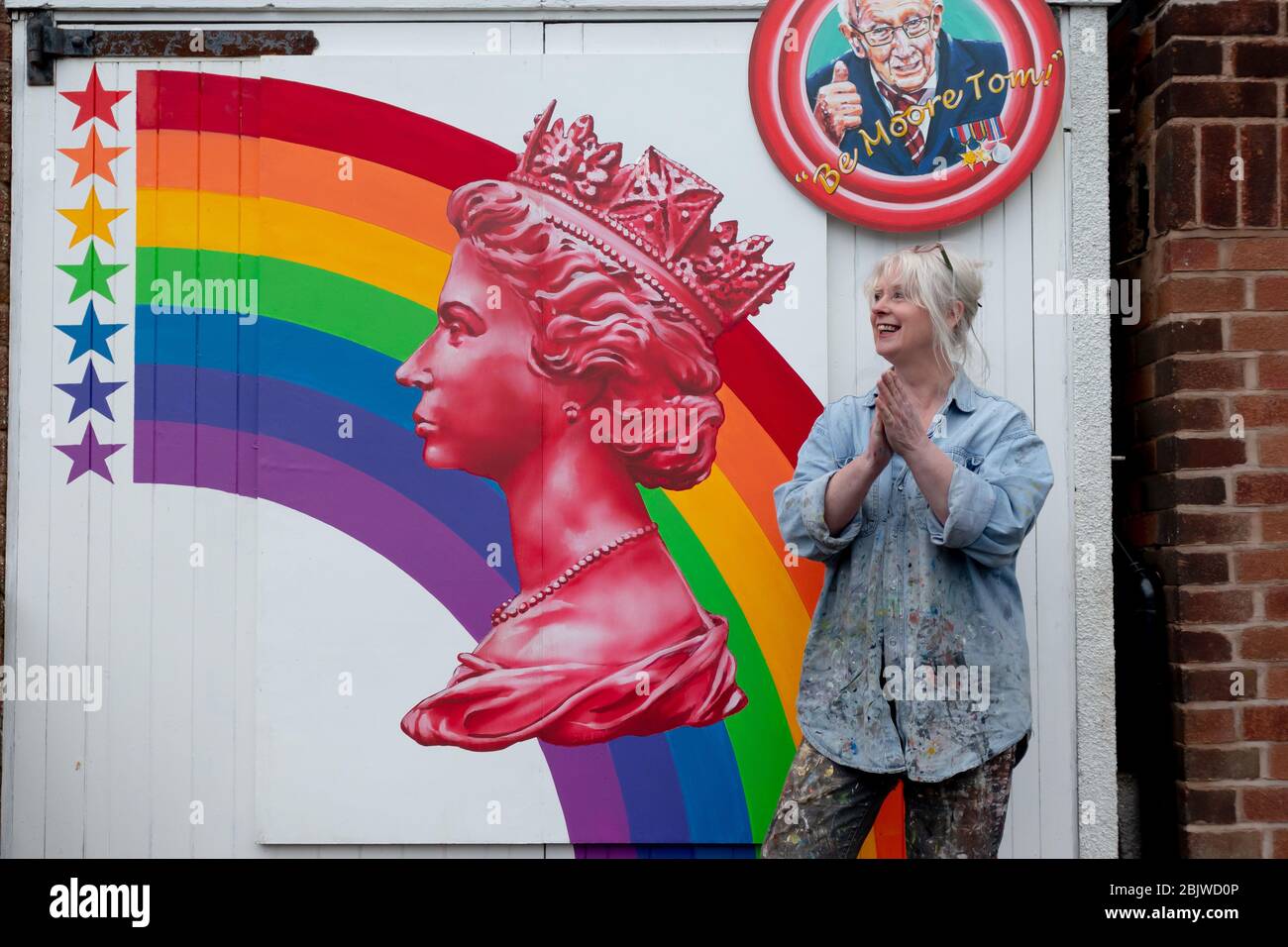 Halesowen, West Midlands, UK. 30th Apr, 2020. Clap for the NHS and frontline workers: theatre set designer Sandra Field, of Halesowen, West Midlands, has painted a beautiful mural on the garage door honouring the NHS and HM Queen Elizabeth with a large portrait of her fom a postage stamp. Credit: Peter Lopeman/Alamy Live News Stock Photo