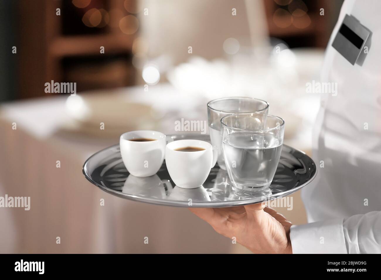 Waiter serving water in restaurant hires stock photography and images