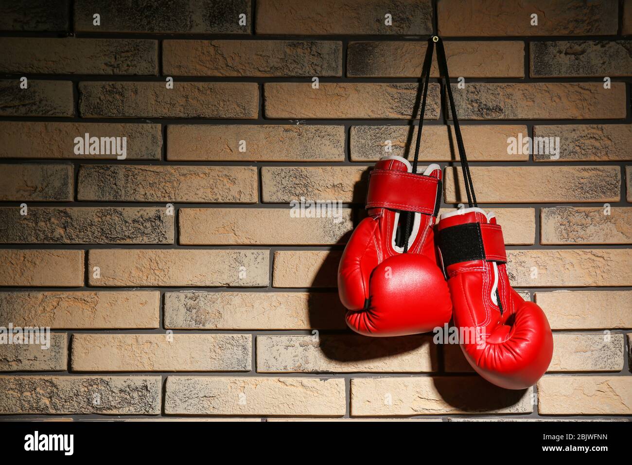 Boxing gloves on brick wall Stock Photo Alamy