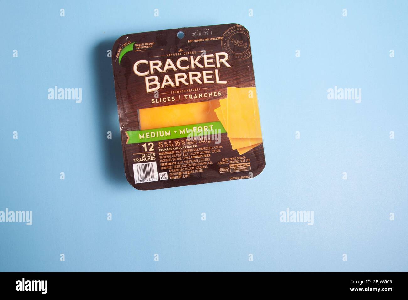 Halifax, Canada - April 11, 2020: A package of re-sealable Cracker Barrel cheese on a blue background Stock Photo