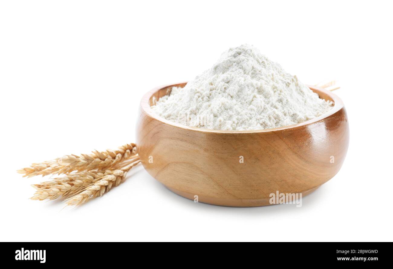 Wheat flour in bowl on white background Stock Photo