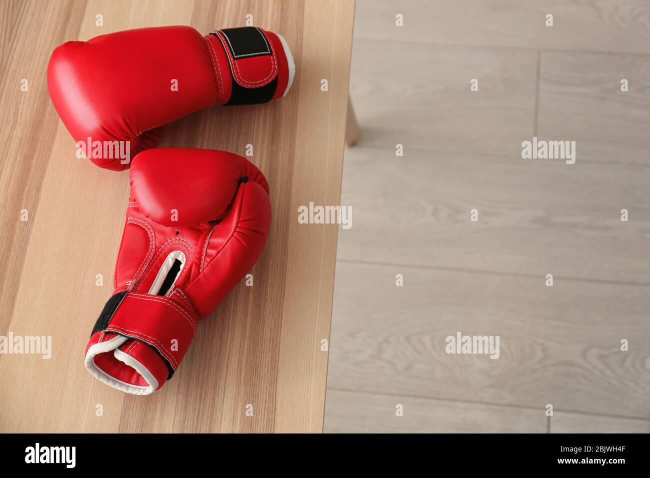 Boxing gloves on table indoors Stock Photo Alamy