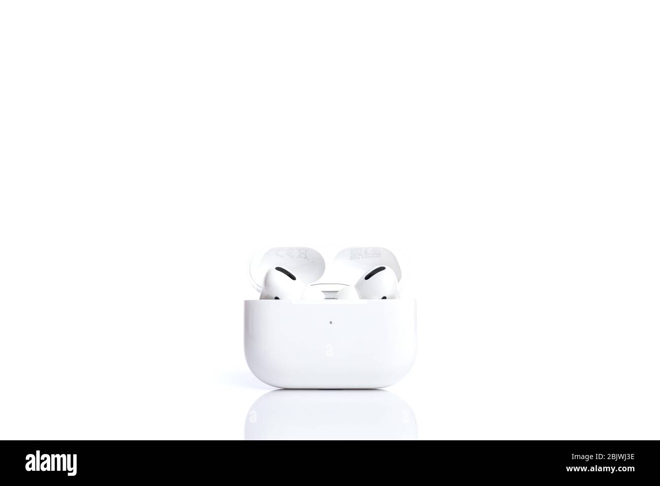 Technologies, electronics. White modern wireless earphones in case isolated on white background Stock Photo