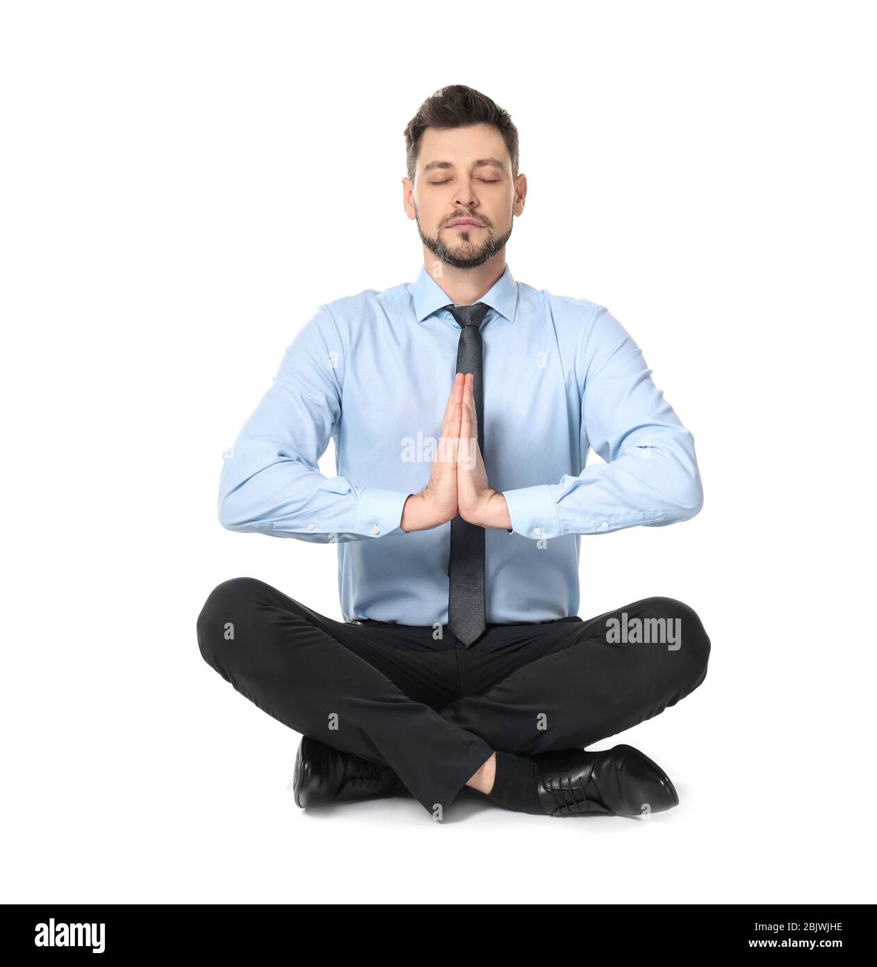 Young businessman meditating on white background Stock Photo - Alamy
