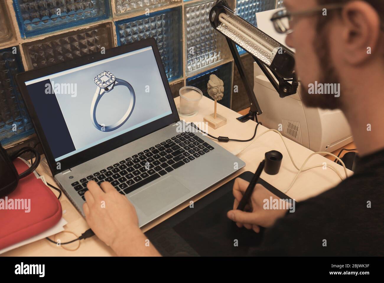 Jewelry designer working on laptop, closeup Stock Photo Alamy