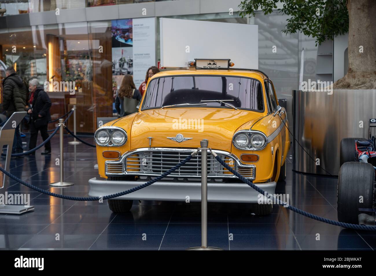 Feb 3, 2020 - Salzburg, Austria: Yellow vintage taxi car in Hangar-7 flying bulls center Stock Photo