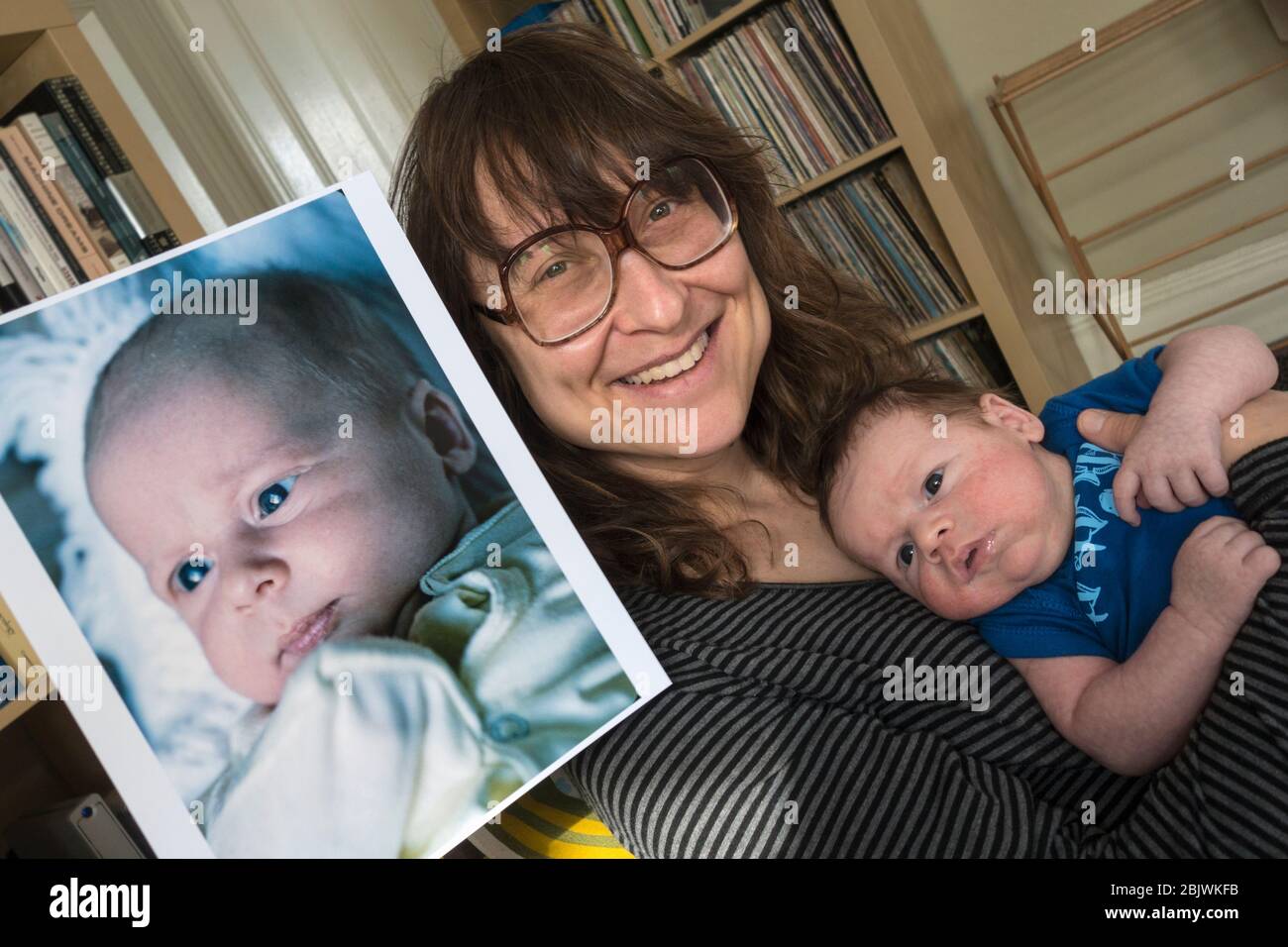 New mother with her month old boy and photo of herself (all model and property released) at one day old. Stock Photo