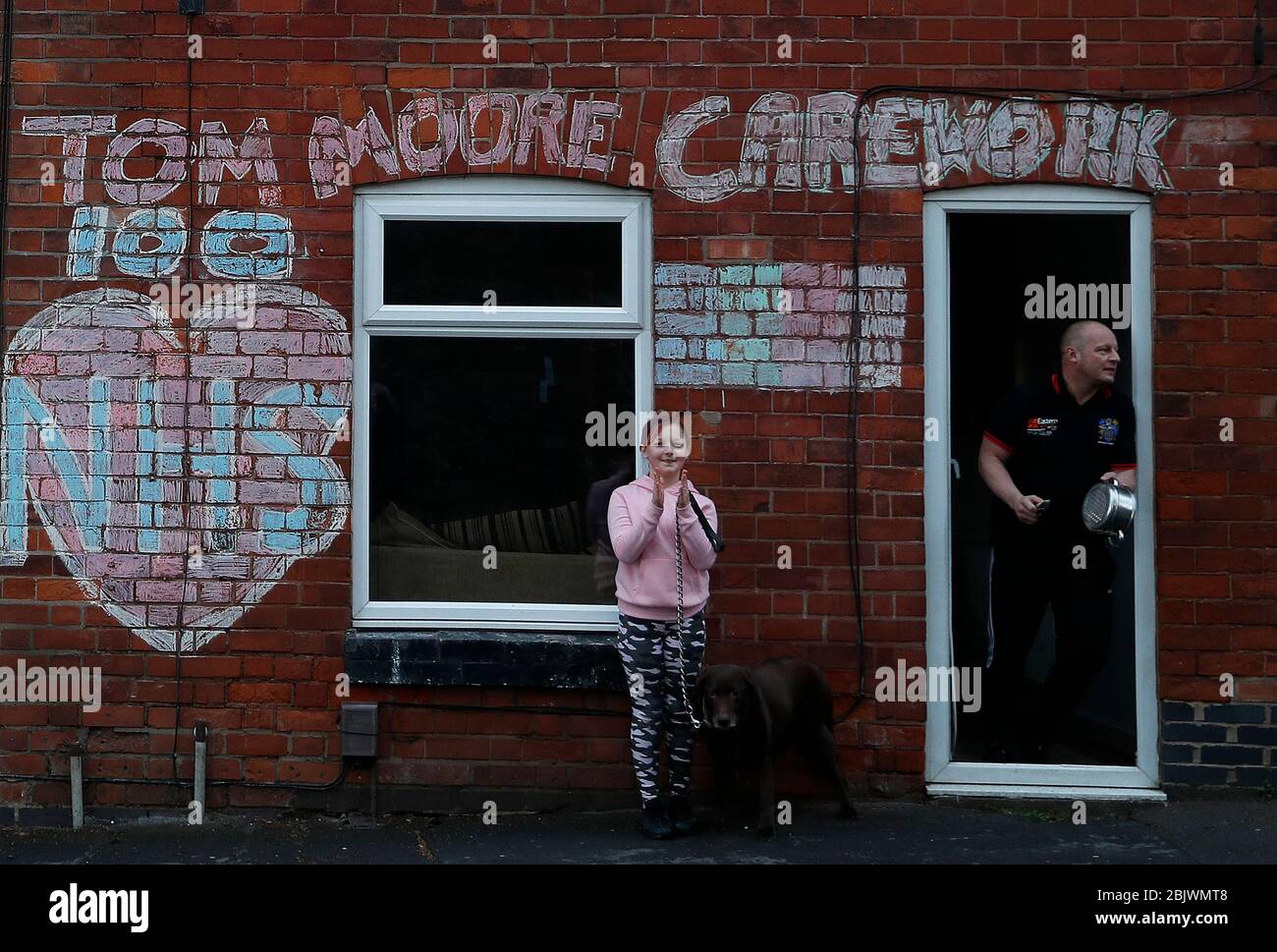 Anstey, Leicestershire, UK. 30th April 2020. Kevin and Ayla Ward applaud to show their appreciation for NHS workers and Captain Tom Moore during the coronavirus pandemic lockdown Clap for Carers event. Credit Darren Staples/Alamy Live News. Stock Photo